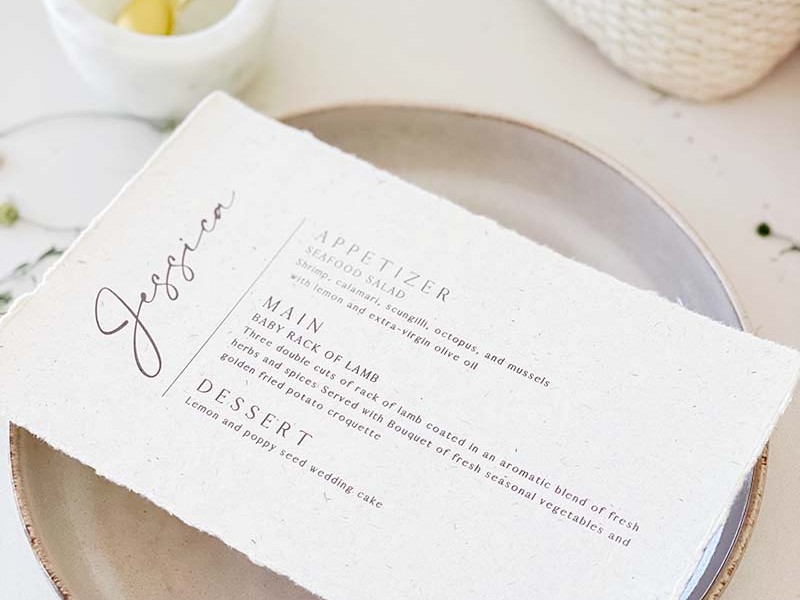 Vintage torn edge menu card with guest name