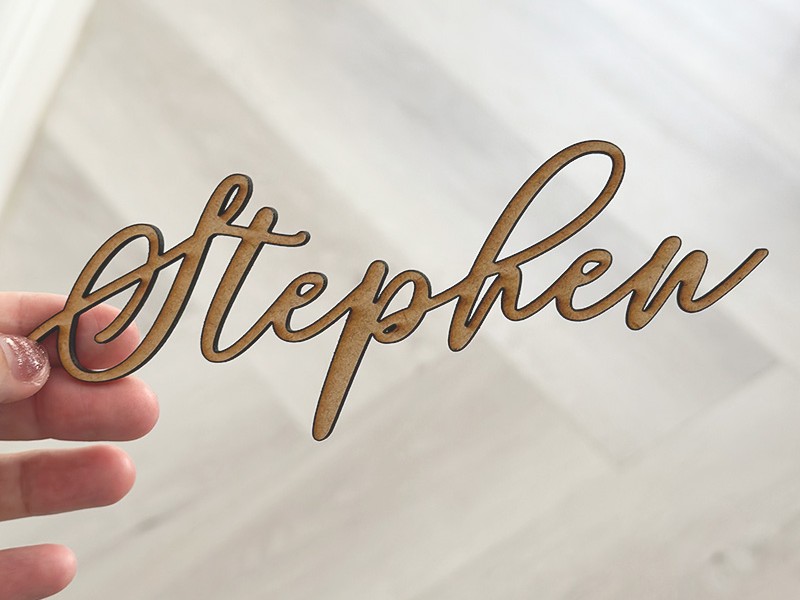 Trusha and Phillip cut out wooden guest names 2